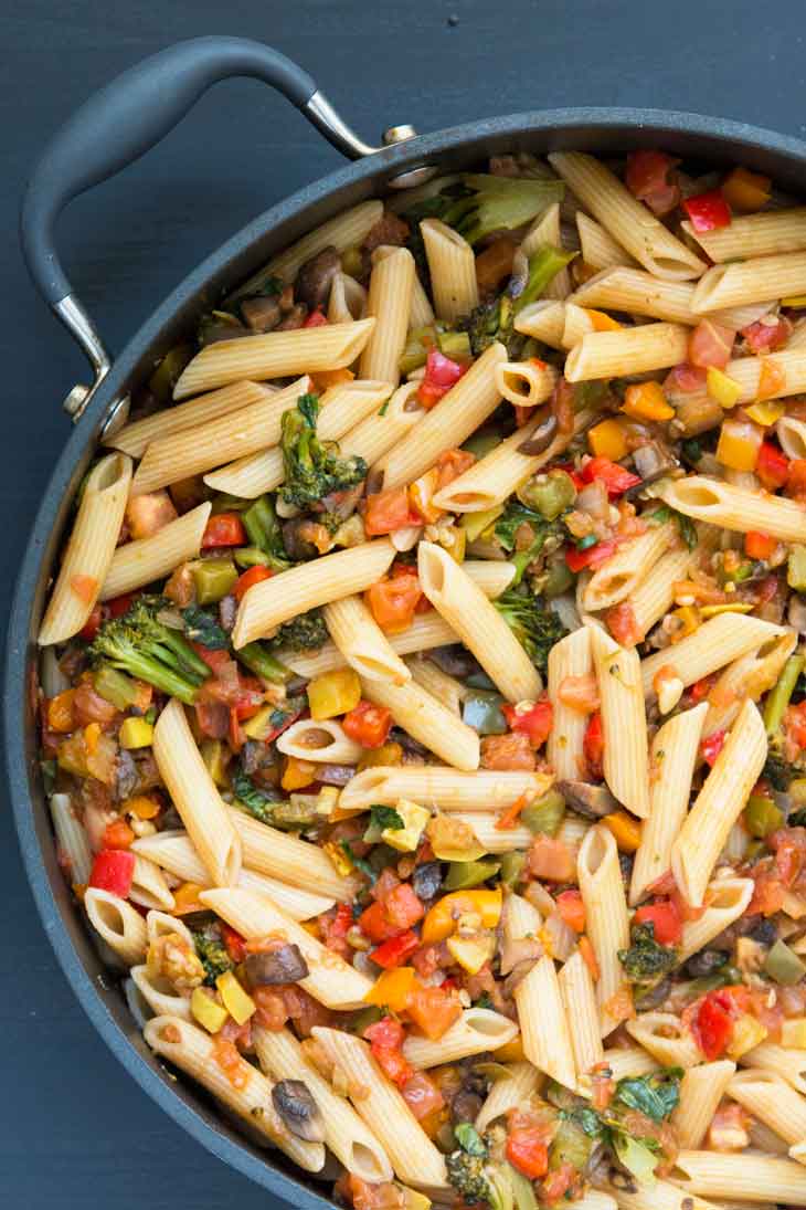 Overhead photograph of a large non stick pan containing pasta with vegetables.