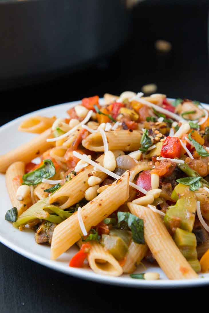 Side photograph showing a closeup italian dish of pasta with veggies.