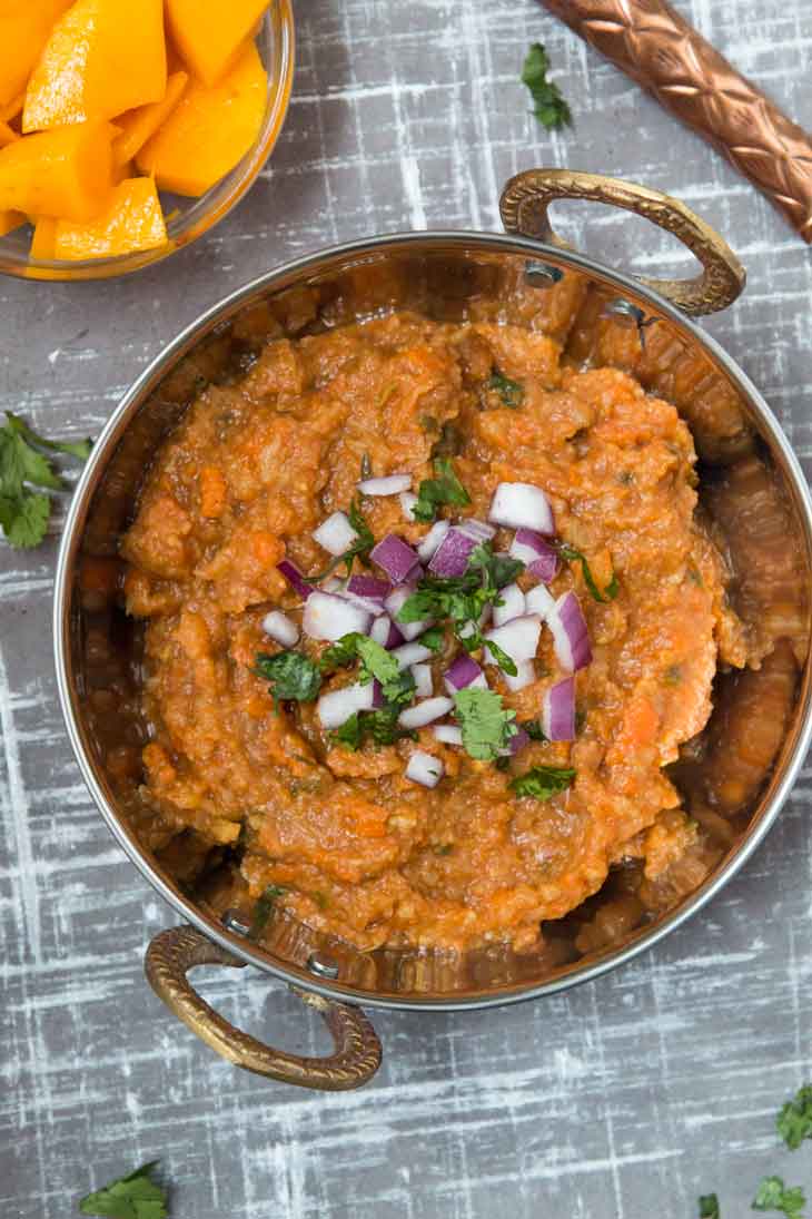 Overhead photograph of Pav Bhaji Masala recipe with fresh mango on the side.