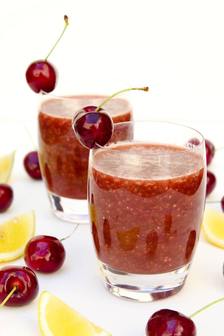 Two glasses of cherry chia fresca garnished with cherries