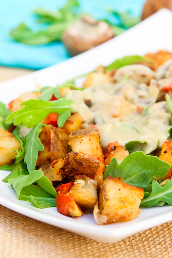 A side shot of loaded potatoes topped with vegan gravy