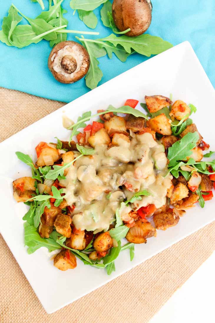 An overhead shot of a breakfast bowl made with loaded potatoes and a mushroom gravy