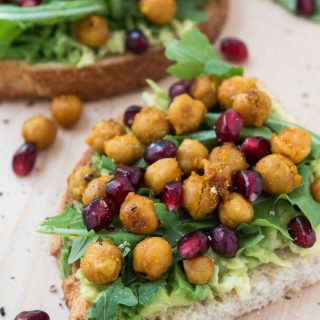 Avocado Toast with Roasted Chickpeas, Arugula, & Pomegranate Seeds #vegan #glutenfree | www.vegetariangastronomy.com