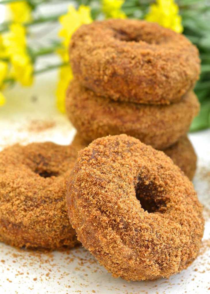 A picture of stacks of pumpkin donuts for a vegan pumpkin recipes roundup.