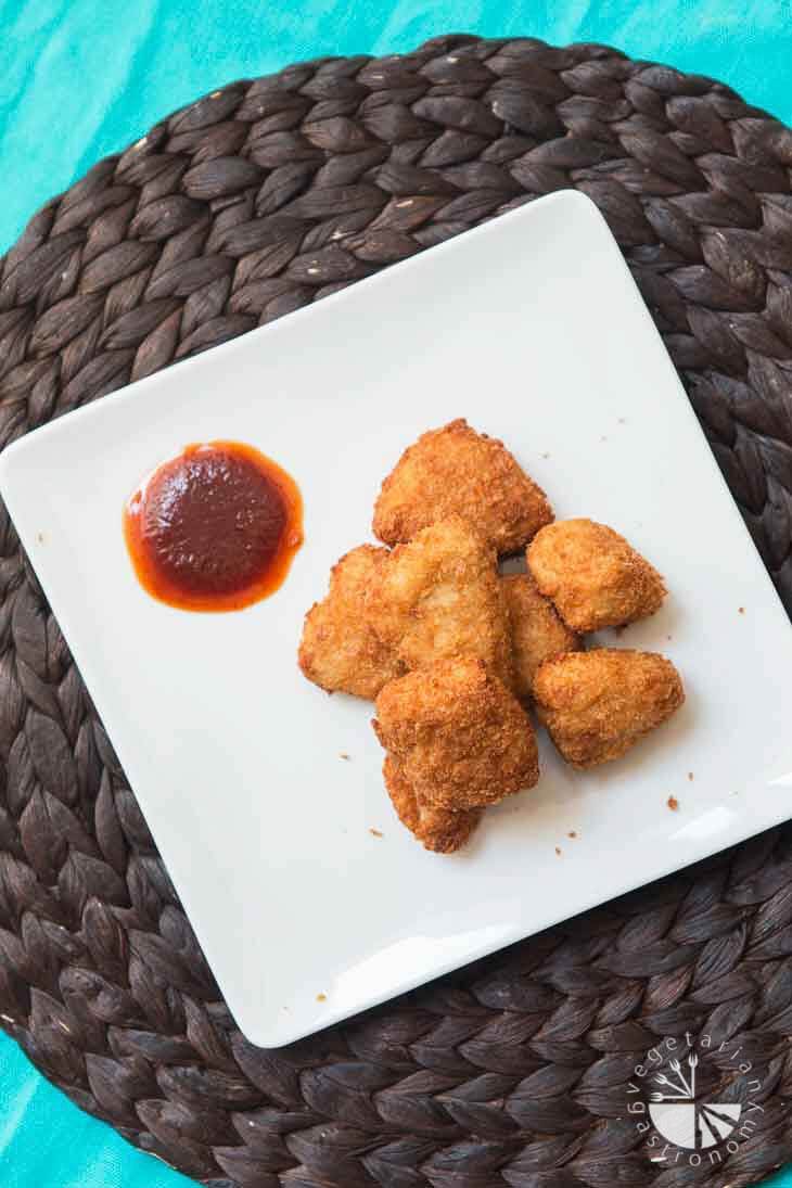Overhead photograph of chick'n nuggets with a side of BBQ sauce. 