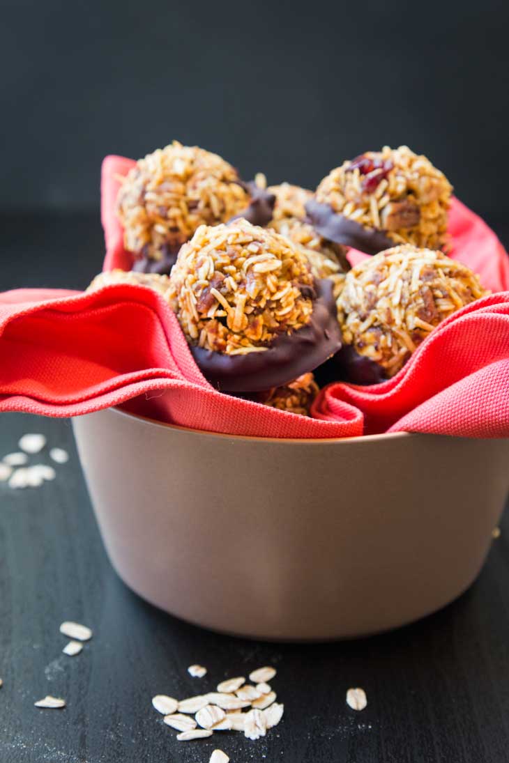 Front photograph of a tan bowl containing an orange napkin filled with vegan pumpkin cookies. 