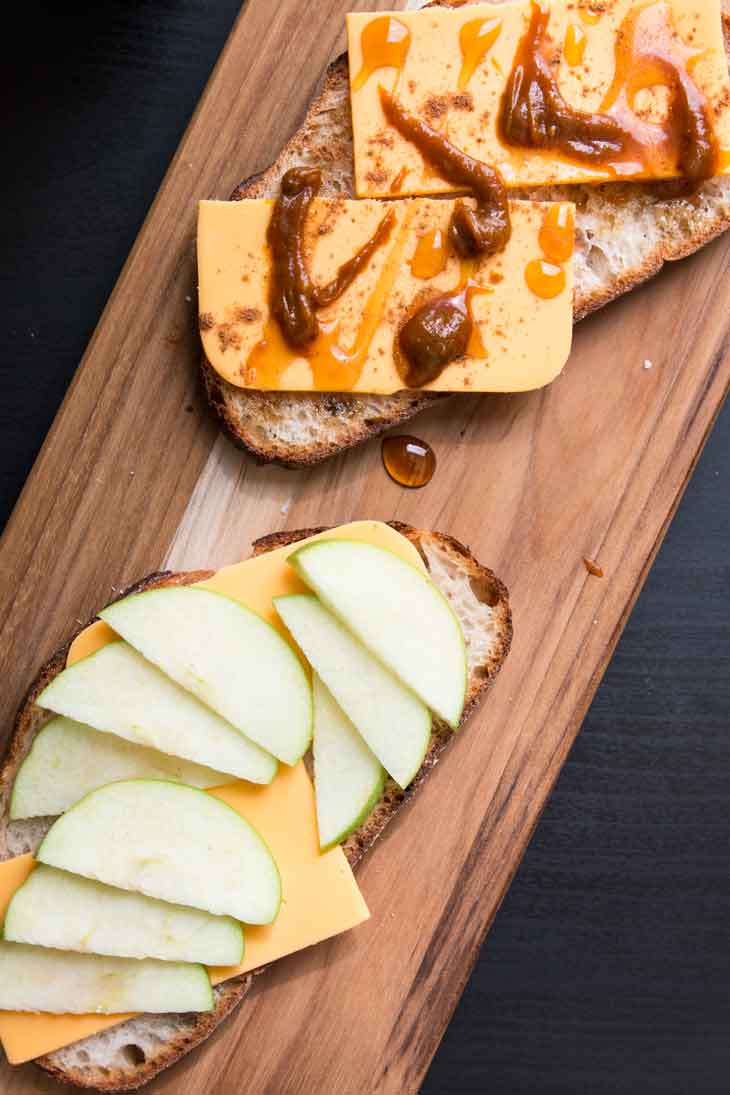 An overhead photograph of a open-faced vegan grilled cheese with apples and pumpkin butter. 