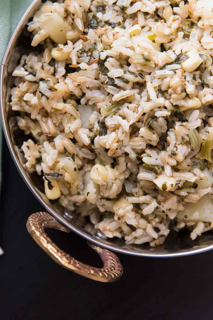 An overhead close-up of vegetable pulau rice recipe in a copper bowl.