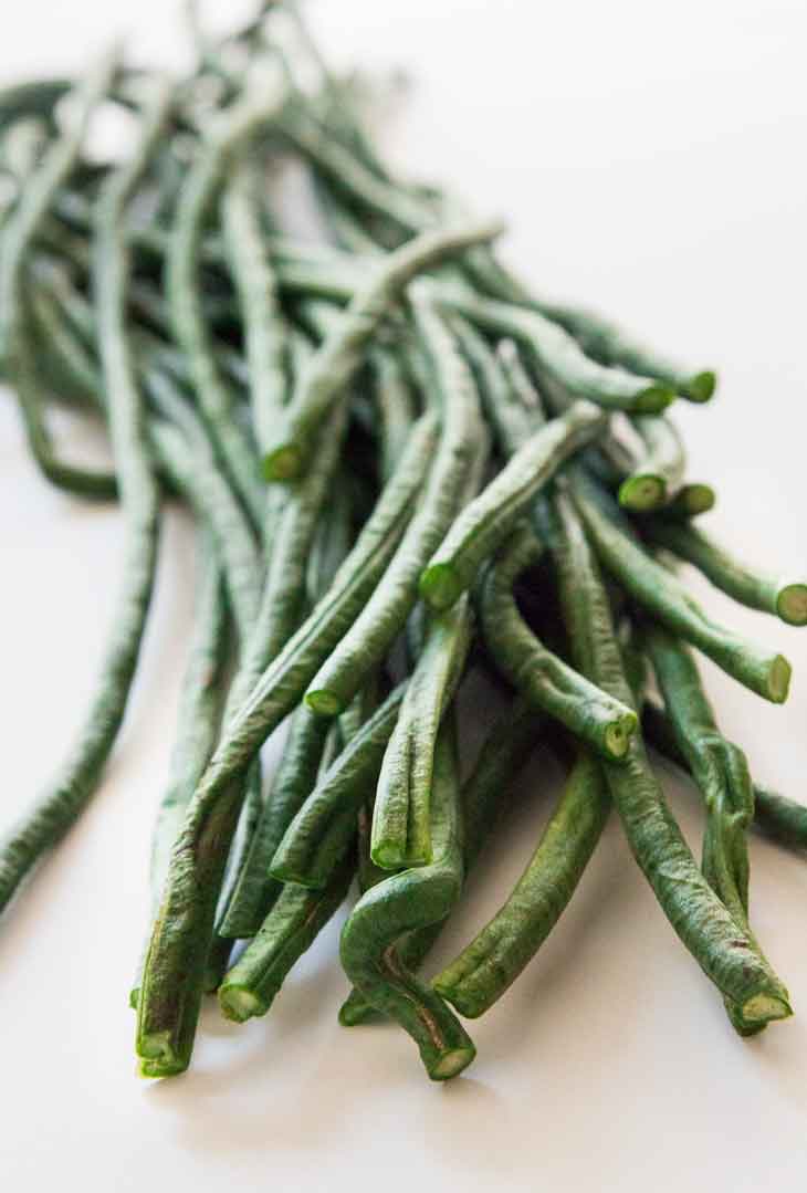 A close up photograph of yard long beans, or green beans.