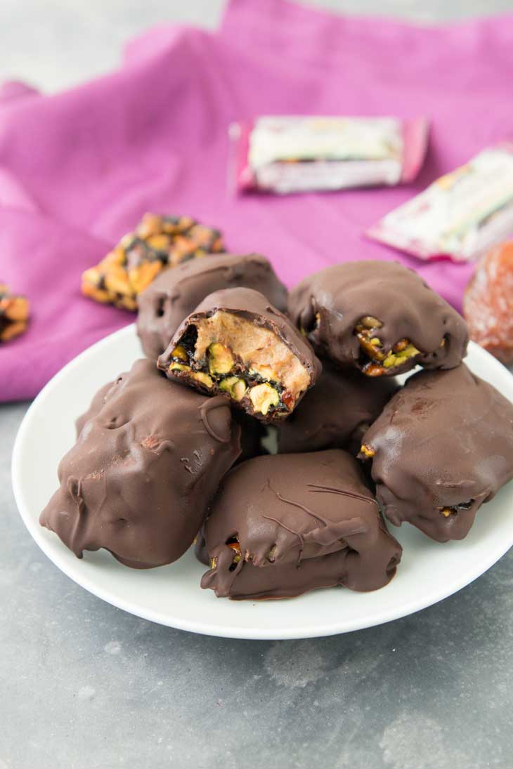 Side plate of vegan chocolate bars with chewy bites in the background. 