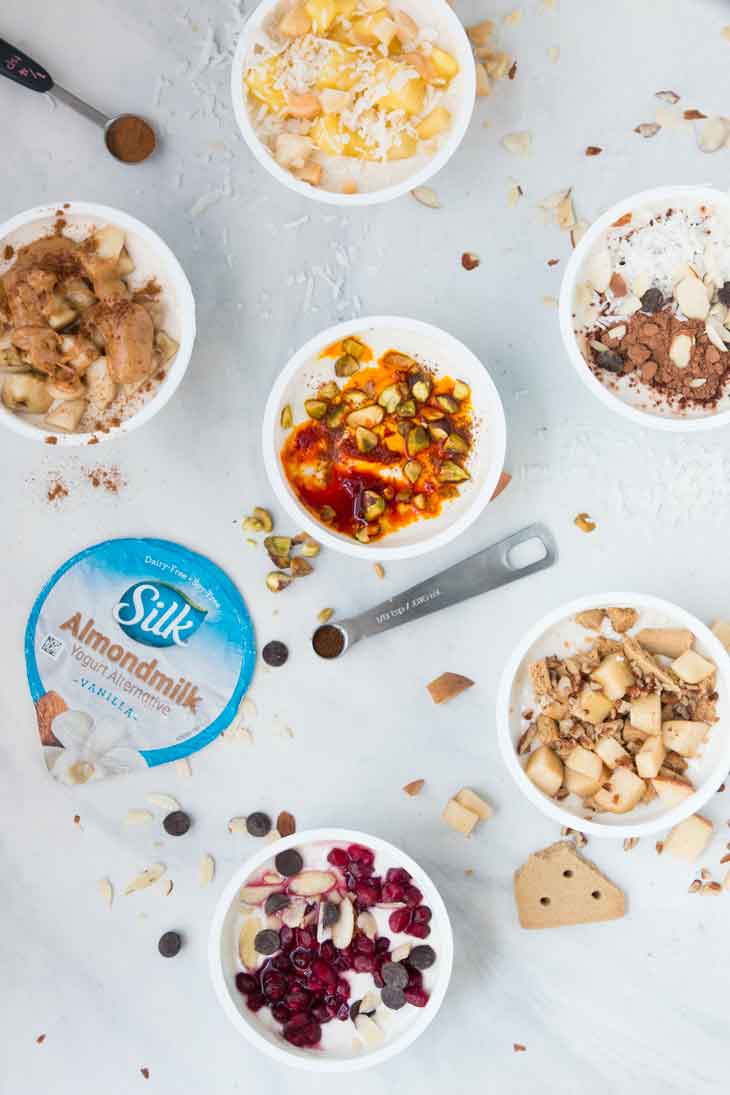 Overhead photograph of 6 healthy yogurt cup combinations. 