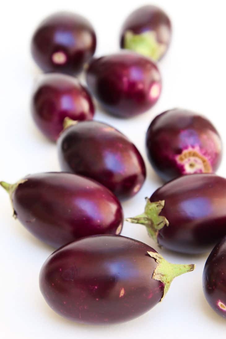 A close up of baby eggplants ready for baking