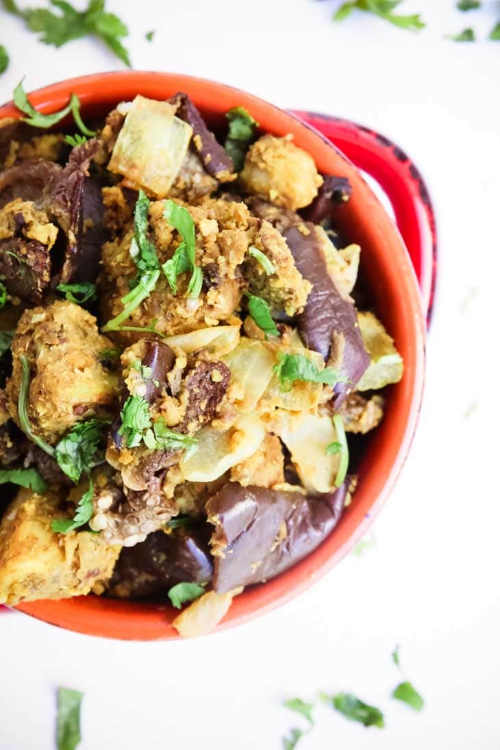 An overhead shot of Indian spiced baked eggplant and potatoes in a bowl