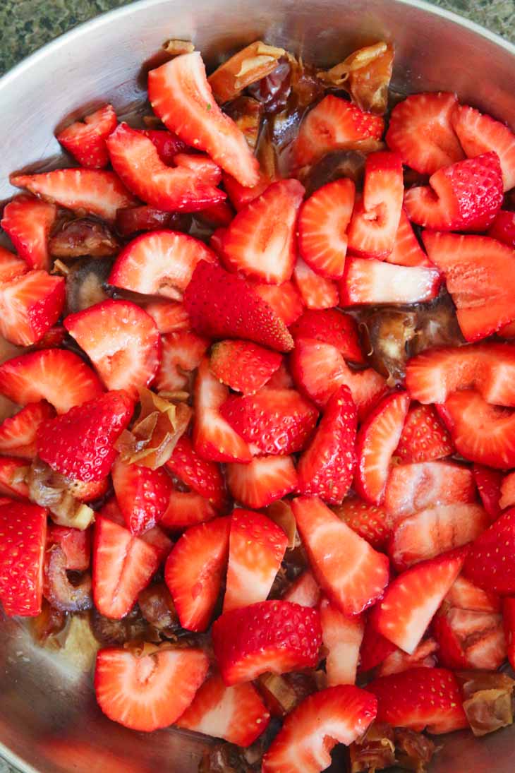 Chopped up strawberries in a bowl with chocolate