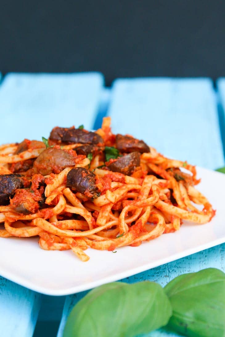 Linguine with roasted mushrooms on a square plate