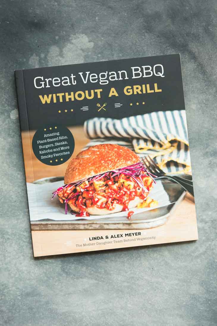 Overhead shot of great vegan bbq cookbook, containing bbq sandwich recipes.