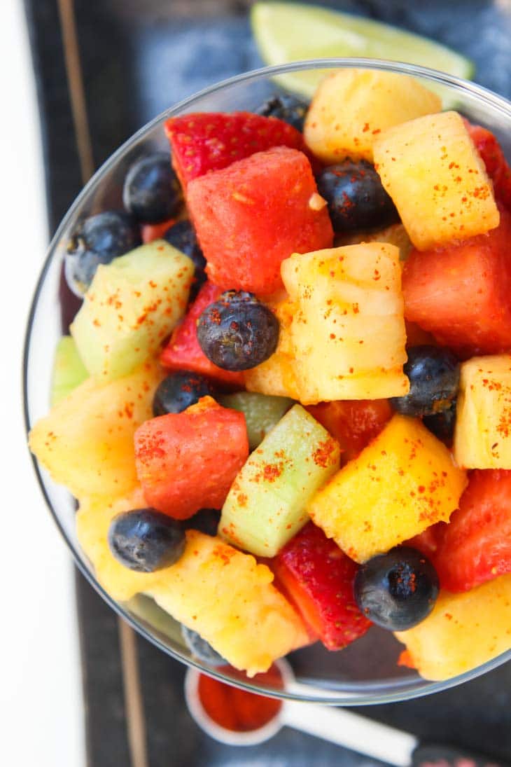 A close up of a homemade fruit salad in a large glass
