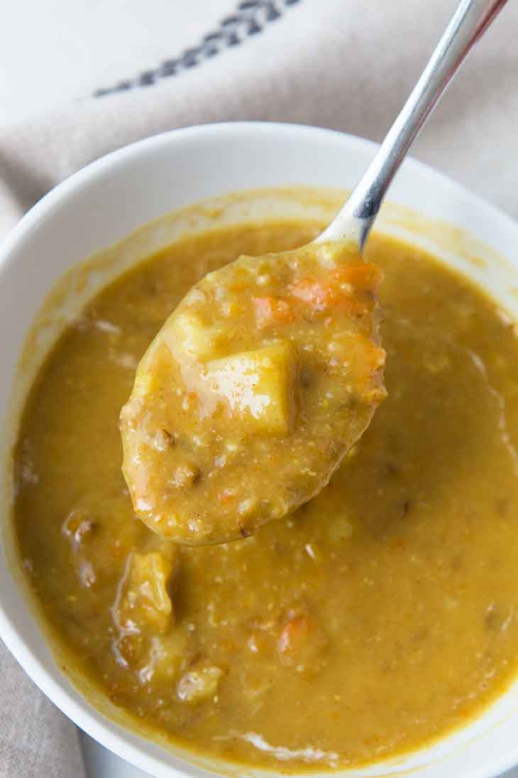 A close-up spoonful of vegan lentil soup.