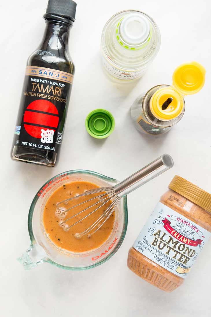 Overhead photograph of the ingredients needed to make a almond butter sauce for a healthy stir fry.