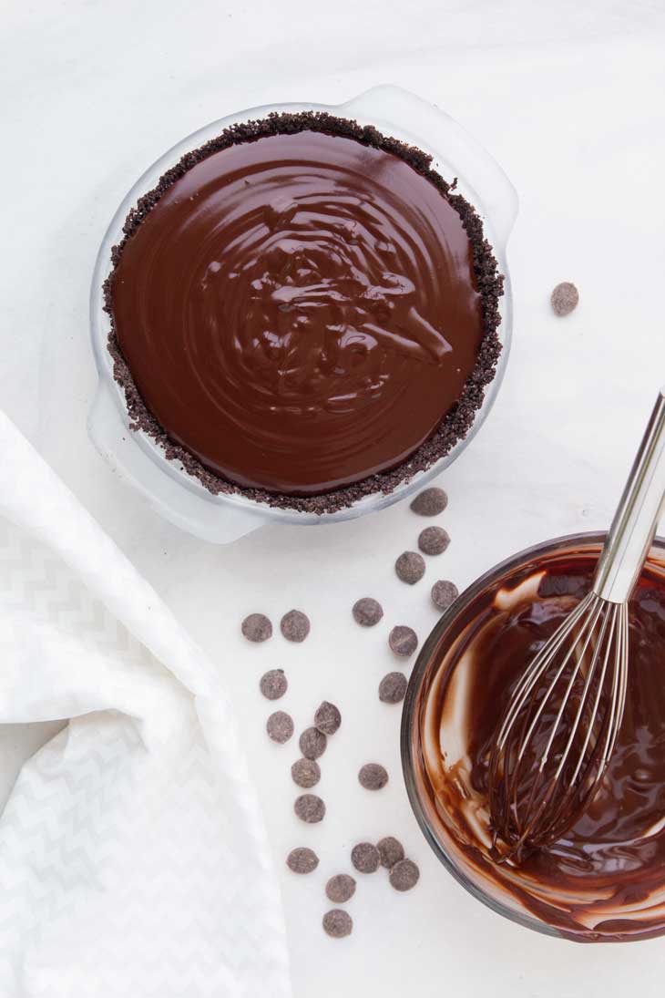 An overhead photograph of the chocolate filling being poured into the vegan chocolate pie.