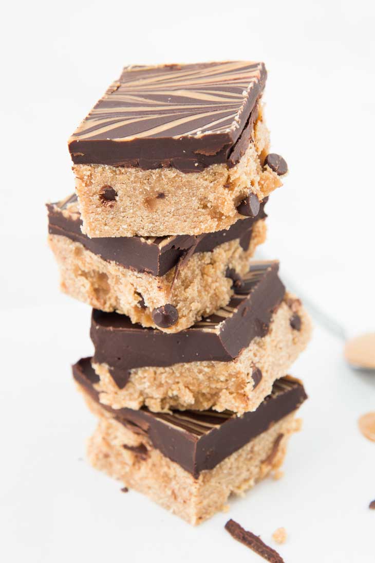 A stack of salted caramel bars with dark chocolate, chocolate chips, and coconut flour.