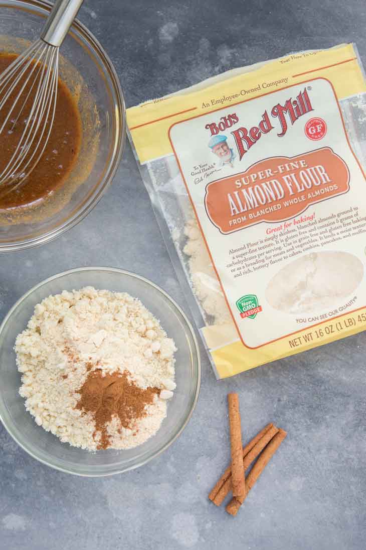 Overhead photograph of almond flour, coconut flour, cinnamon mixture, cinnamon sticks, and Bob's Red Mill almond flour. 