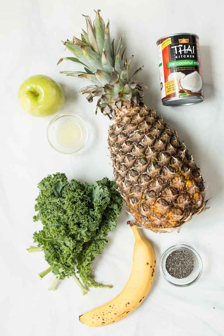 Overhead shot of all the ingredients for a pineapple kale smoothie recipe.